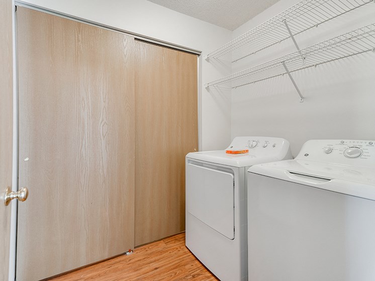 laundry room with tan sliding closet doors